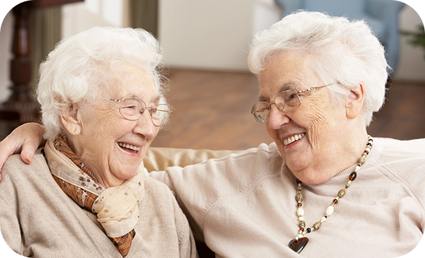 Two older women sitting next to each other.