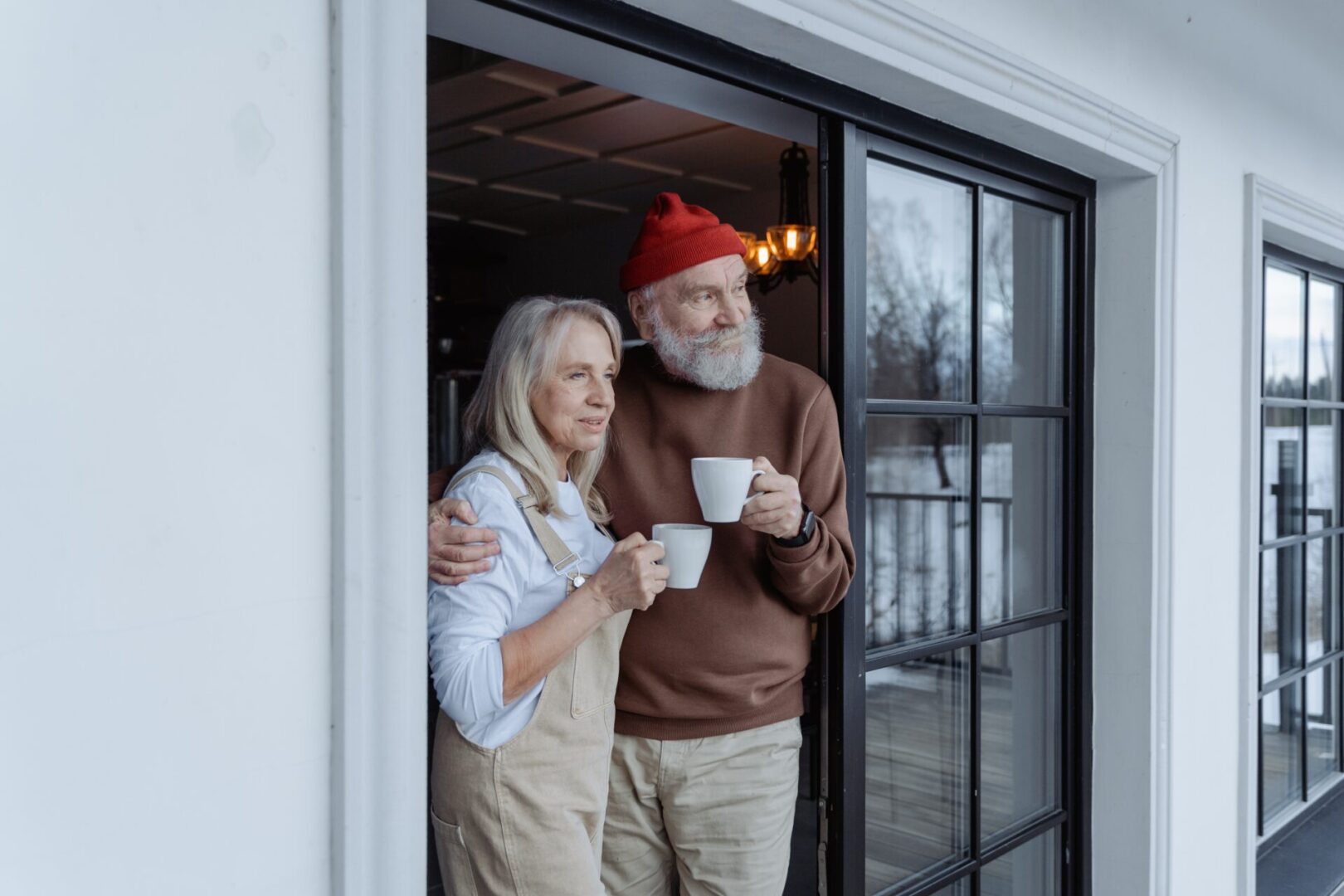 A man and woman holding coffee mugs in their hands.