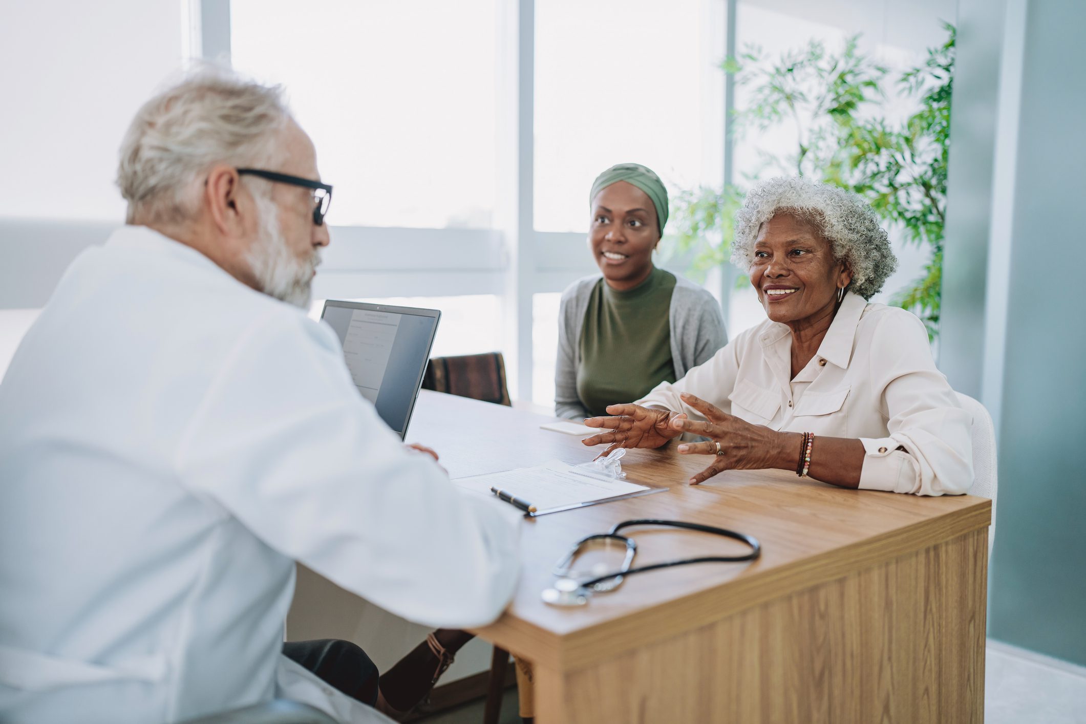 Senior patient and family talking to doctor