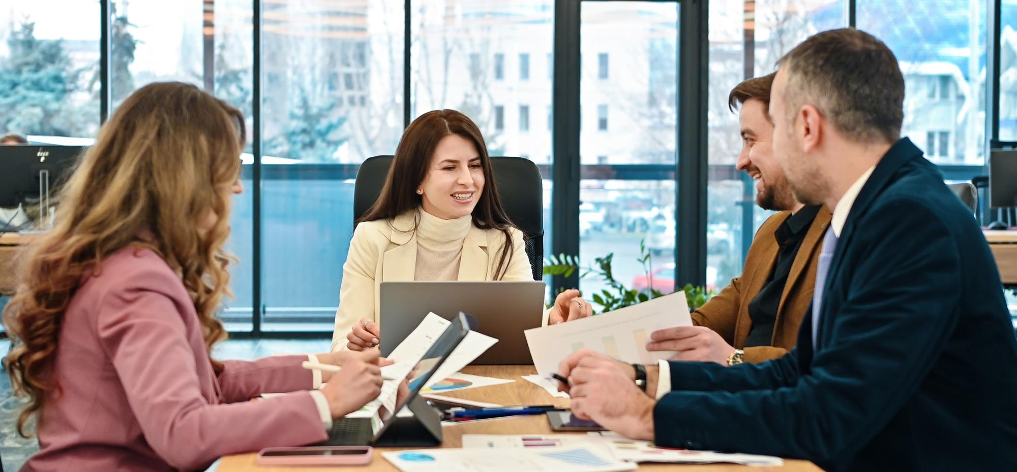A group of employees sitting in conference room discussing Small Group Healthcare Coverage for their New Jersey business