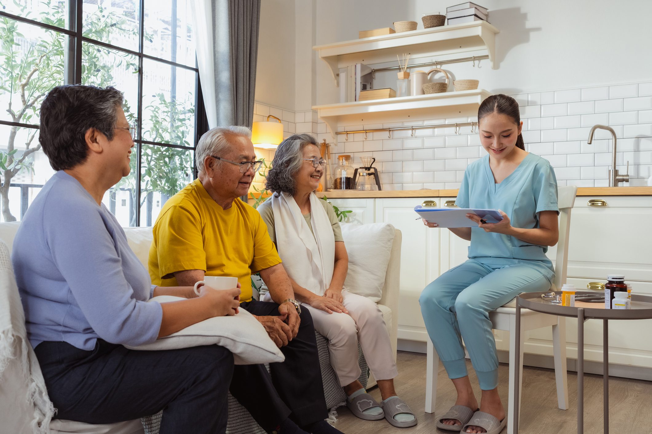 Caregiver showing tablet to elderly people