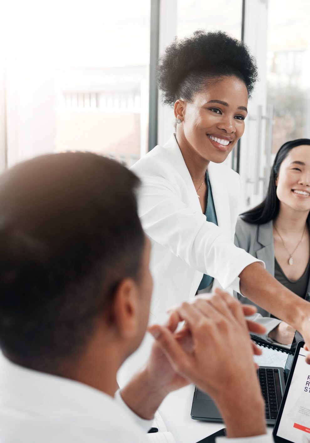 Diverse team shaking hands during business meeting