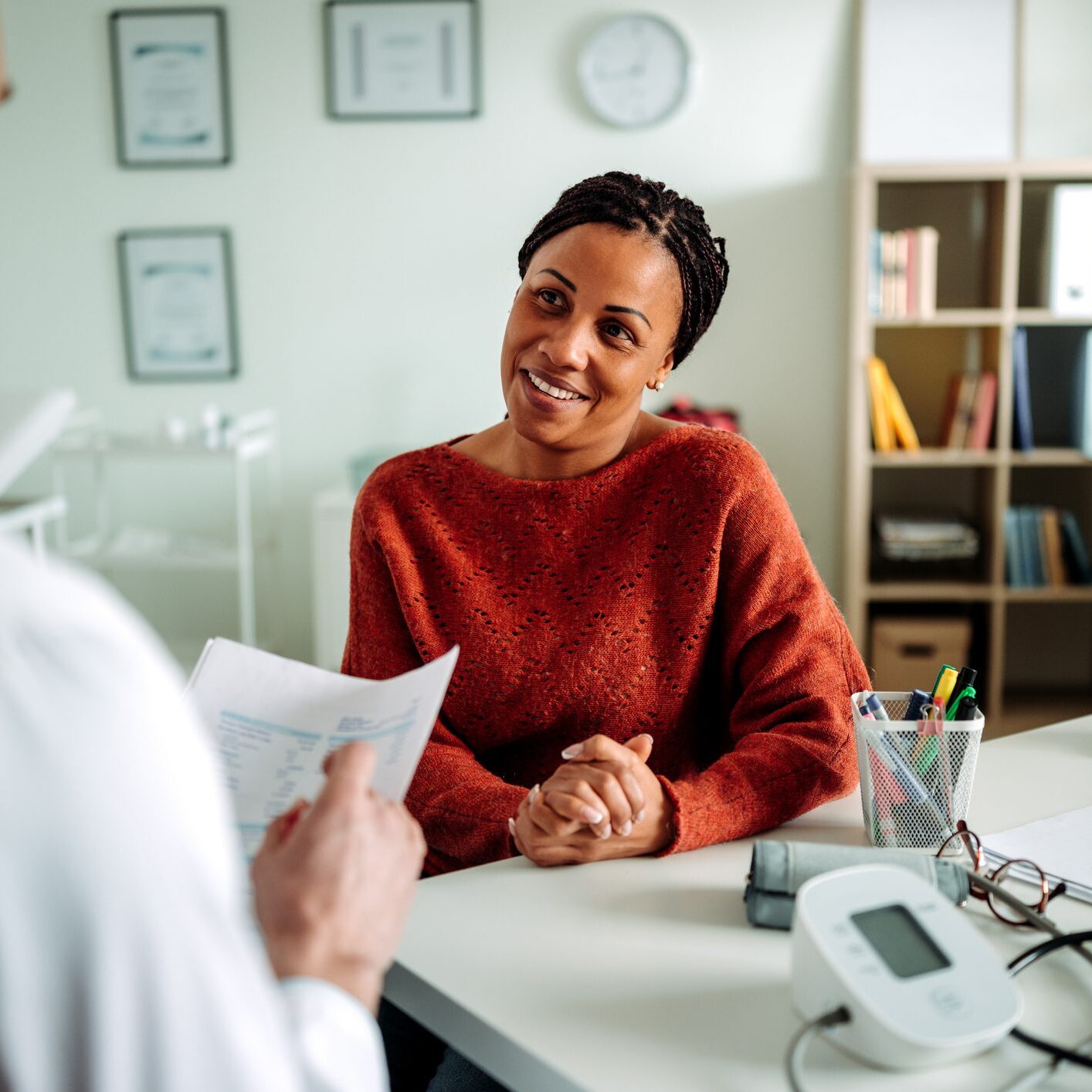 Doctor speaking with patient about what their Health Insurance Plan covers during office visit