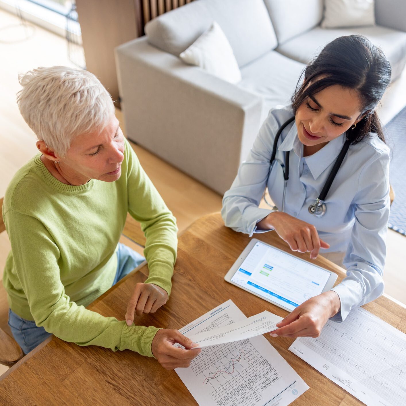 Doctor reviewing medical paperwork with older patient